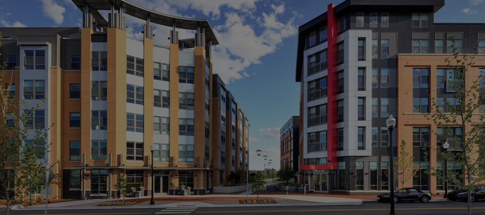 New mixed use apartment buildings with ground-floor retail and streetlights