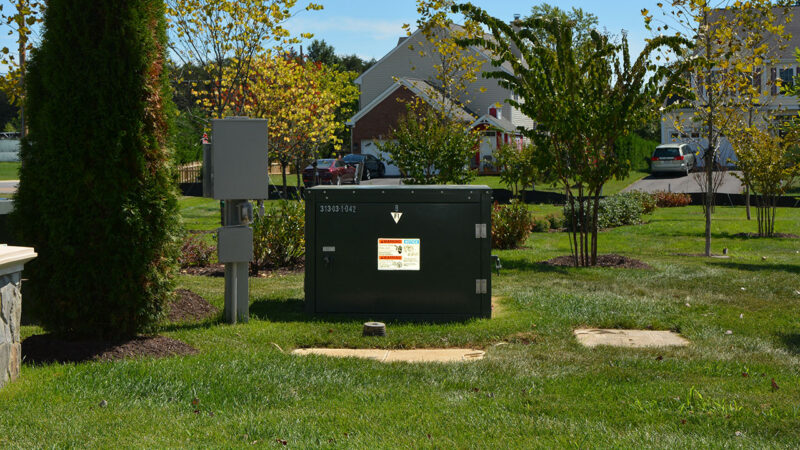 Pad-mounted transformer and telecom pedestal in a residential neighborhood