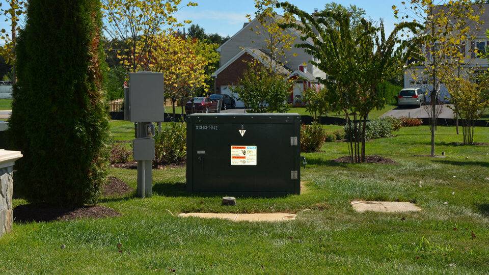 Pad-mounted transformer and telecom pedestal in a residential neighborhood